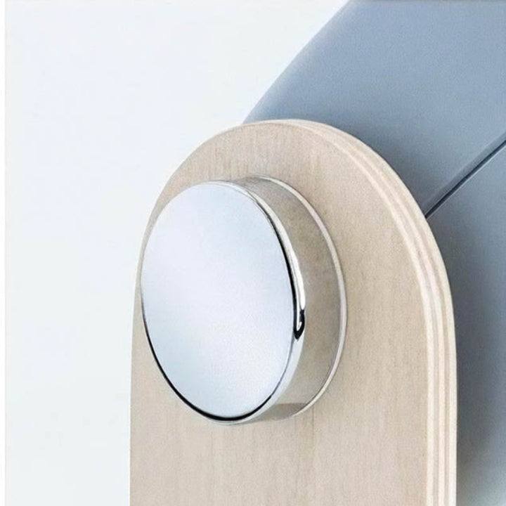 Detail of LYKT lamp head and soft matte lens design, set into a natural wooden handle structure.