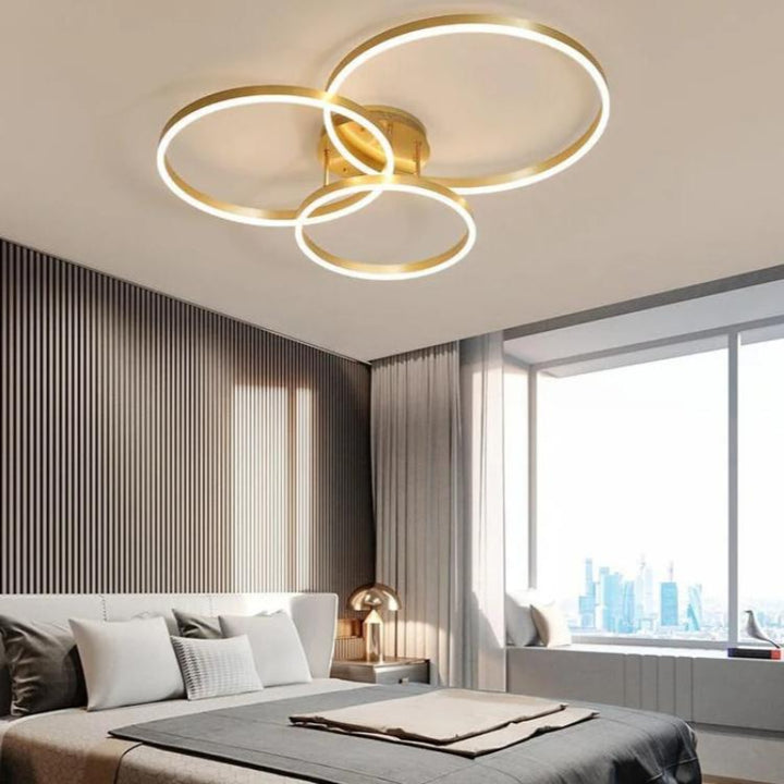 RINGE LED Ceiling Light Illuminating a Modern Living Room – Stylish multi-ring chandelier casting a warm, ambient glow in a contemporary living room setting, highlighting its energy efficiency and elegant design. Variant2