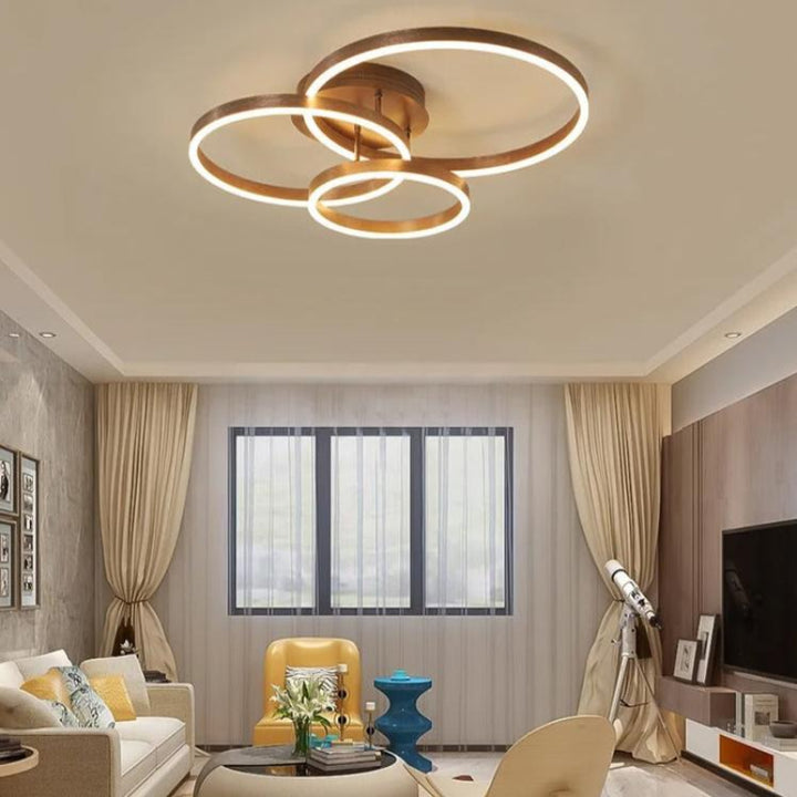 Ilumination of RINGE Multi-Ring LED Chandelier in a Bedroom – Chic coffee-toned RINGE ceiling light mounted in a minimalist bedroom, providing soft, flicker-free illumination and enhancing the room's modern decor.