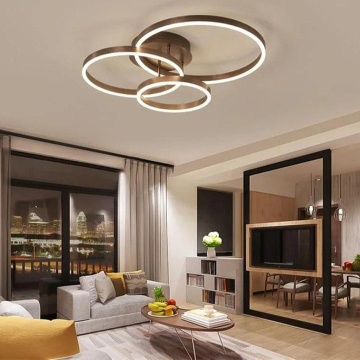 RINGE LED Ceiling Light Illuminating a Modern Living Room – Stylish multi-ring chandelier casting a warm, ambient glow in a contemporary living room setting, highlighting its energy efficiency and elegant design.