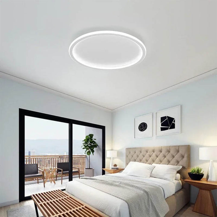 Nordic Essentials RUND LED ceiling light in black, 80cm, illuminating a modern bedroom with Tricolour brightness.