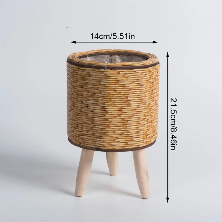 Cylindrical rattan plant basket with short wood legs, natural finish, styled with succulents, Nordic Essentials uk