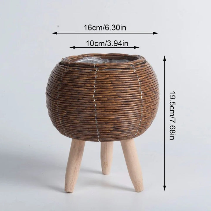 Round rattan plant basket with short wood legs, natural finish, styled with succulents, Nordic Essentials uk