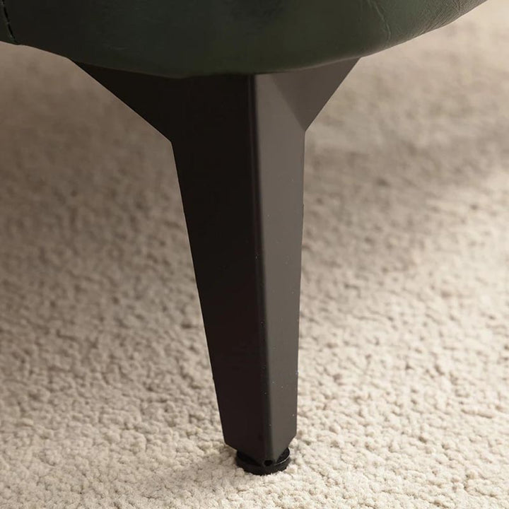 Close-up of tapered wooden leg – sturdy base for compact ottoman or footstool