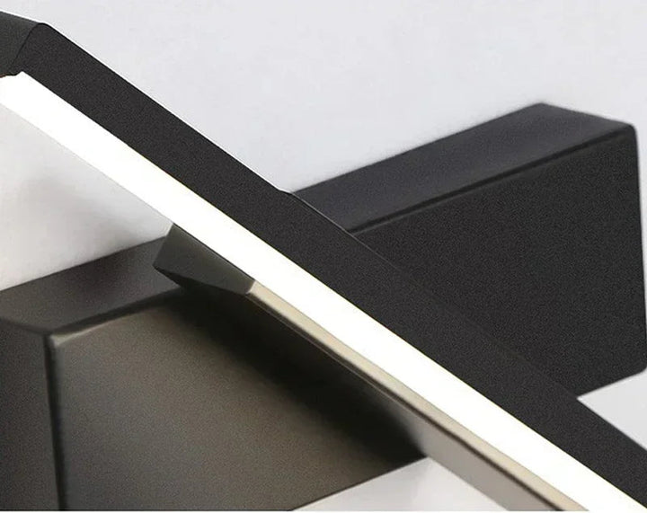 Close-up of a black rotatable led wall light on gray background