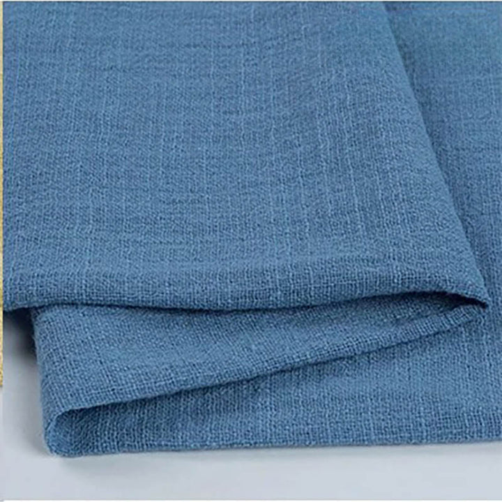 A white set table featuring blue cotton napkin