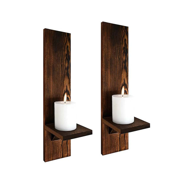 Two wooden wall-mounted candle holders with white candles on a white background