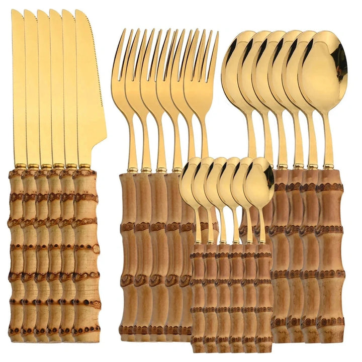 Gold cutlery set with wooden handles on a white background