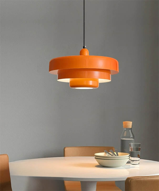 Orange SKIVE Nordic pendant lamp with tiered metal shade, warm light for uk reading nooks, living rooms, or cosy interiors