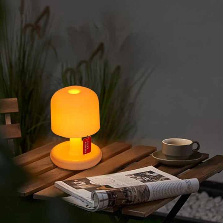 Portable LED mushroom night light on a coffee table, creating warm ambient glow in a cosy living room.