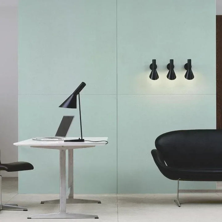 Black SPIRE industrial desk lamp on white office table with laptop, Scandinavian style.