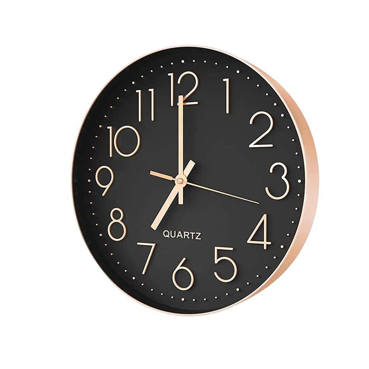 Black wall clock with gold hands on a white background