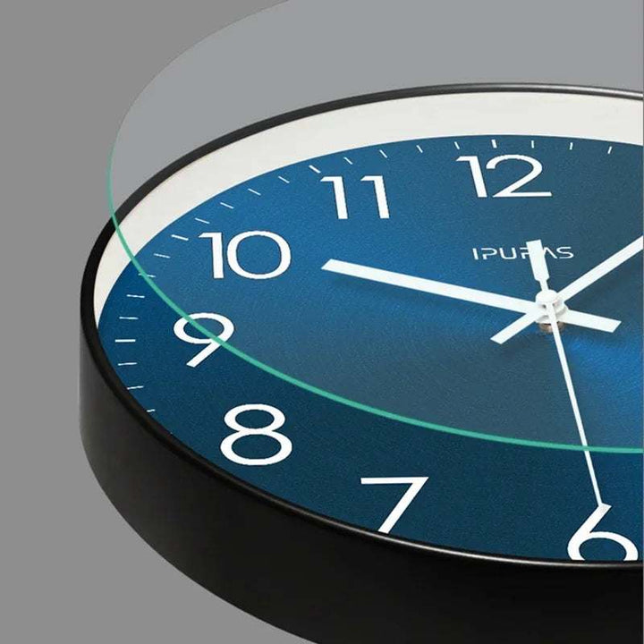 Wall clock with blue face and black casing on a grey background