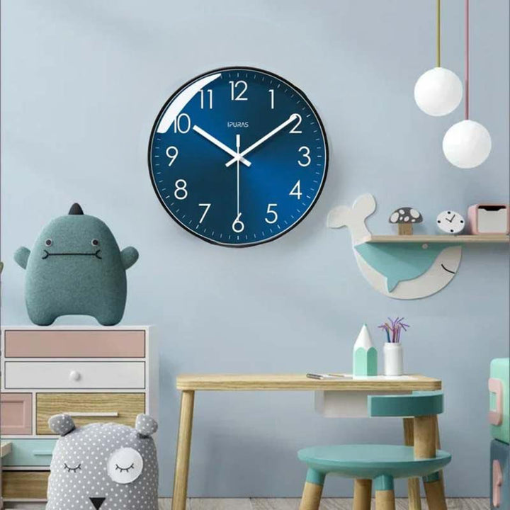Children's room with a blue wall clock, toy, and small table.