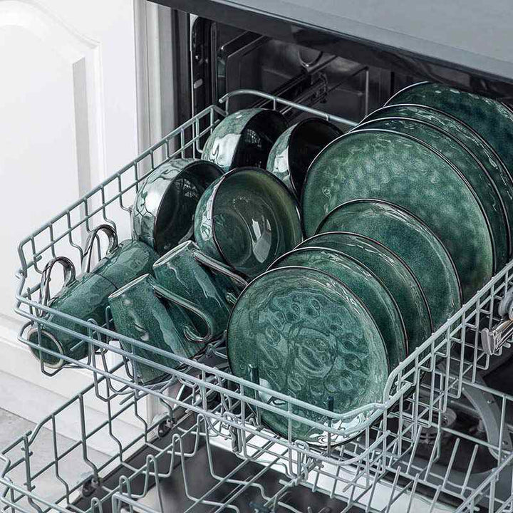 Dishwasher with  teal ceramic dinnerware plates inside