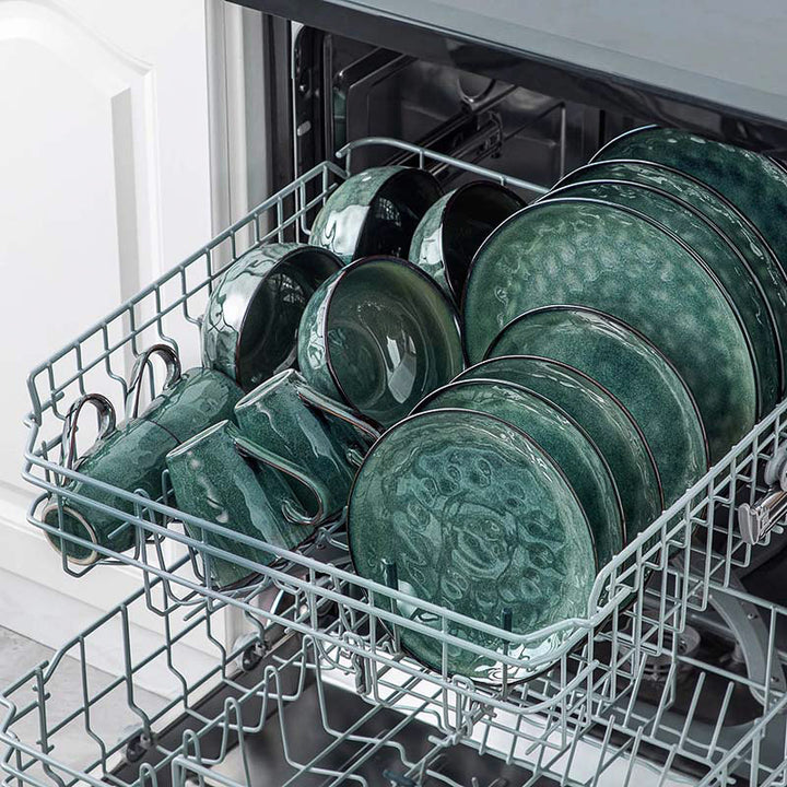 Dishwasher with  teal ceramic dinnerware plates inside