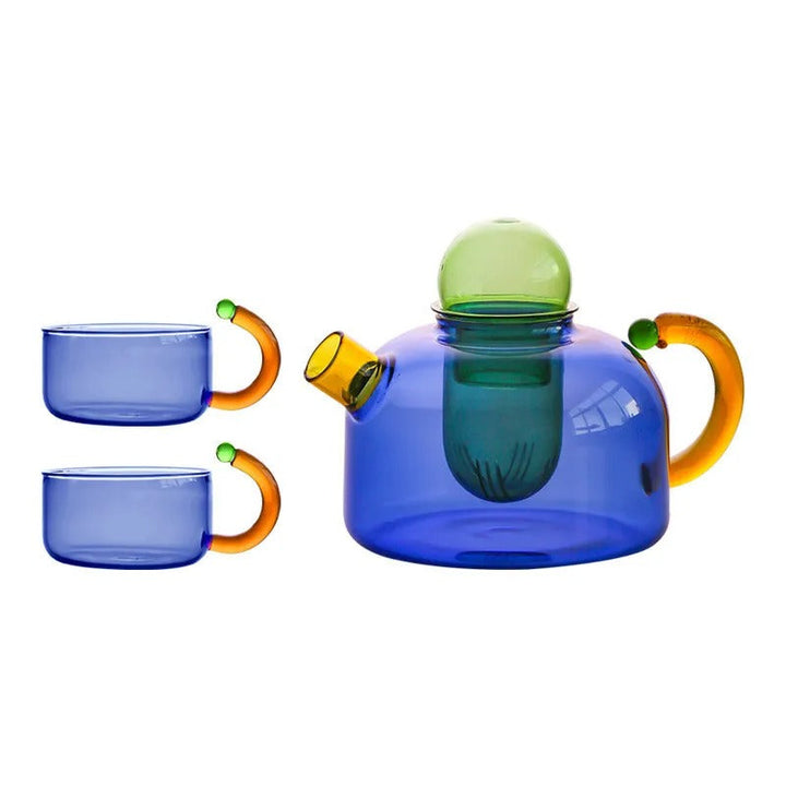 Blue glass teapot and two cups with orange handles on a white background