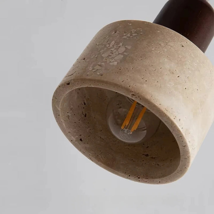Stone lampshade with a light bulb inside on a gray background