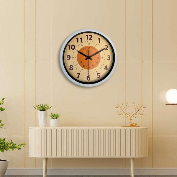 Beige and orange minimalist wall clock displayed above sideboard in living room