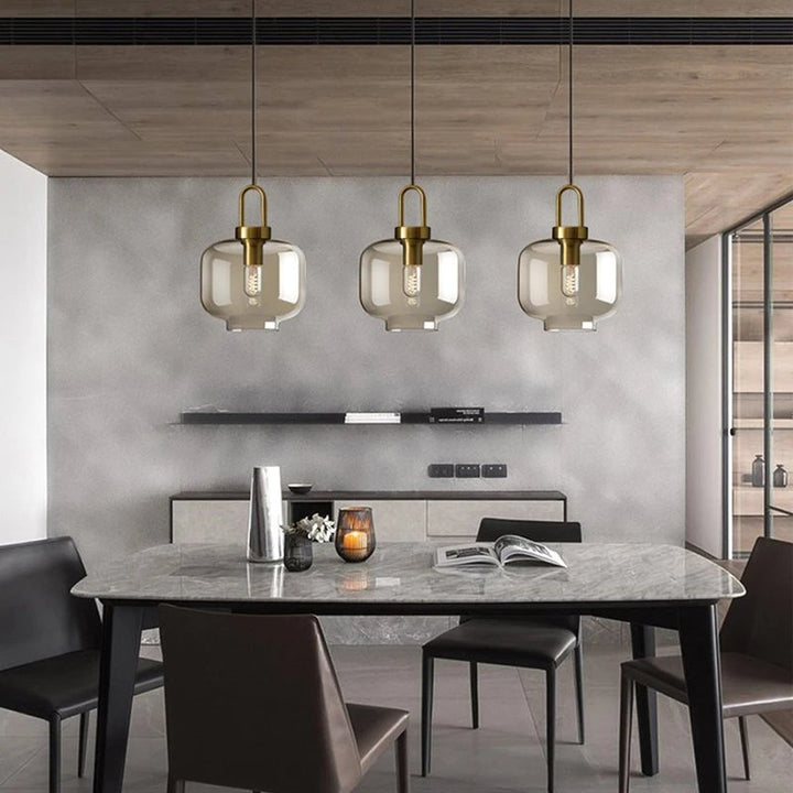 GLASSET Collection industrial glass pendant lamp with a sleek metal frame, modern design, and warm LED lighting for kitchen or dining room.