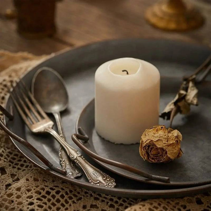 Distressed vintage metal tray, Scandinavian style, used as a decorative base for candles.
