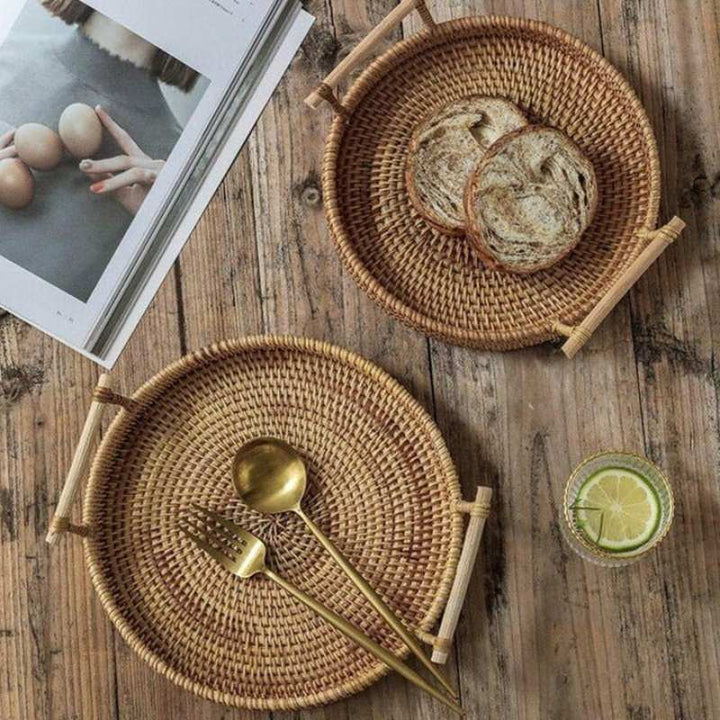 Pair of woven rattan trays with bread and cutlery on rustic wooden table, Scandinavian-inspired serving set