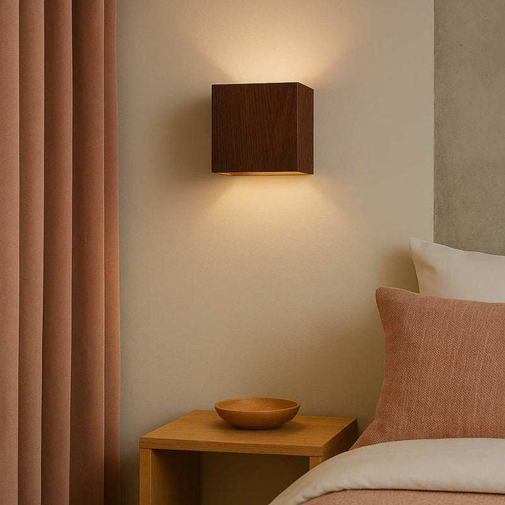 Dark walnut wooden wall light LED sconce illuminating bedroom with Nordic style décor
