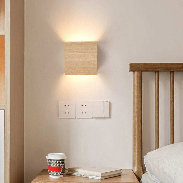 Light oak wooden wall light LED sconce placed beside bed with Nordic furniture styling
