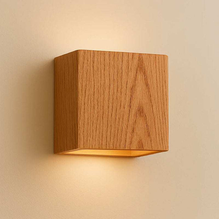 Close-up of oak finish wooden wall light with cube design and LED illumination
