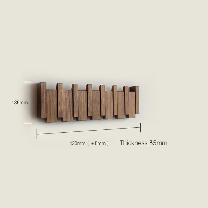 Wooden wall-mounted coat rack with dimensions on a beige background