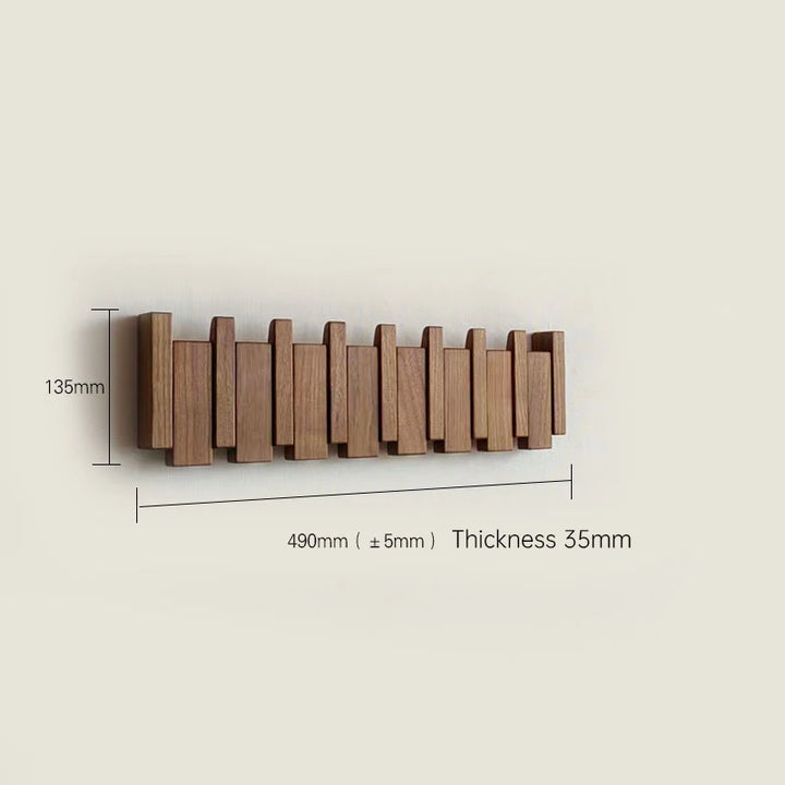 Wooden wall-mounted coat rack with dimensions on a beige background