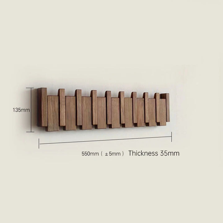 Wooden wall-mounted coat rack with dimensions on a beige background