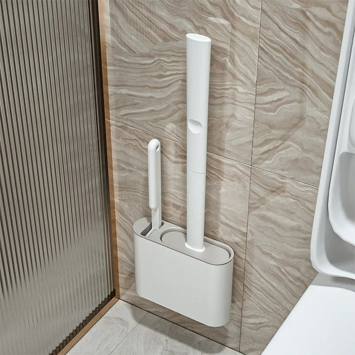 White cleaning brush set with holder against a tiled bathroom wall.