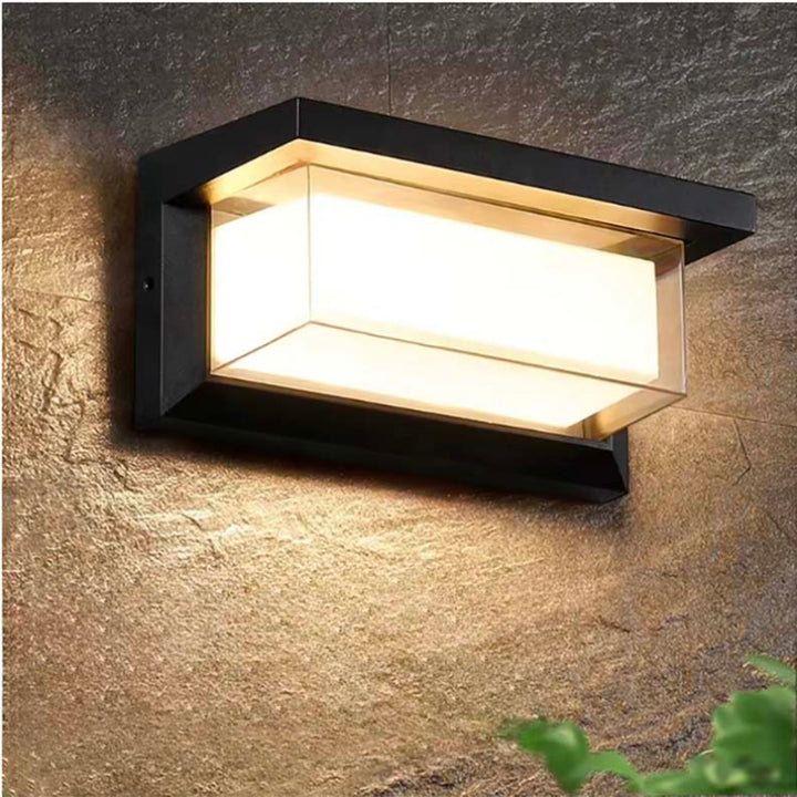 Motion sensor wall light with modern black frame and warm LED glow, waterproof design for outdoor garden or porch lighting