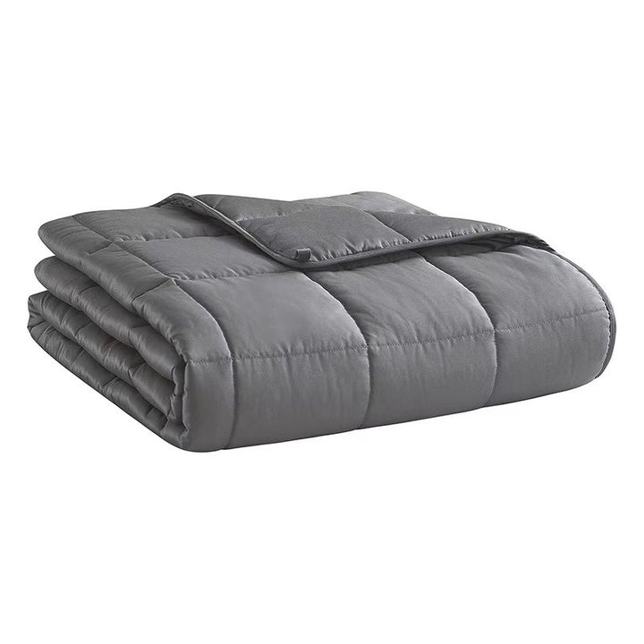 Folded gray weighted blanket on a white background