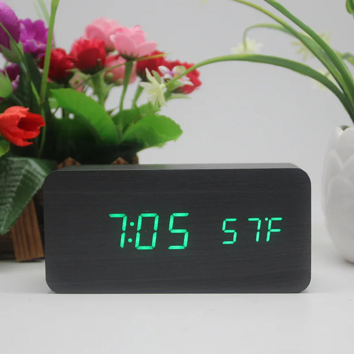 Black wooden alarm clock with green LED display showing time and temperature
