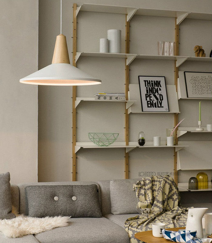Living room with a gray sofa, wooden pendant lamp, and shelves with decor items.