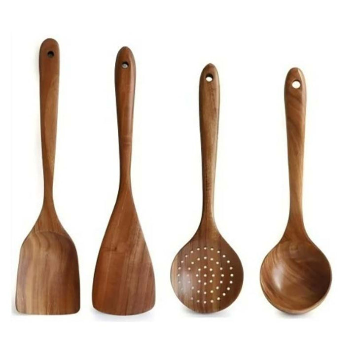 Set of four wooden kitchen utensils on a white background