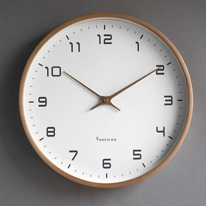 Wall clock with wooden frame and white face on a grey background
