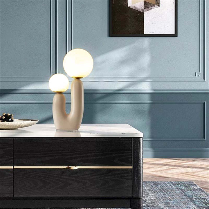 Decorative table lamp on a marble surface with a blue wall in the background