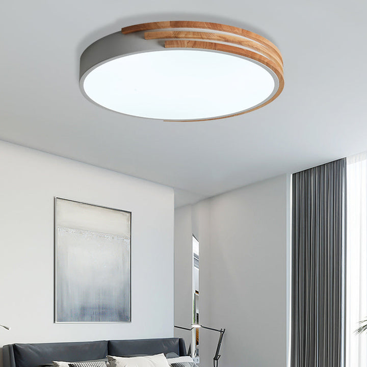 Scandinavian LED ceiling lamp above bed, white and wood finish for serene bedroom décor