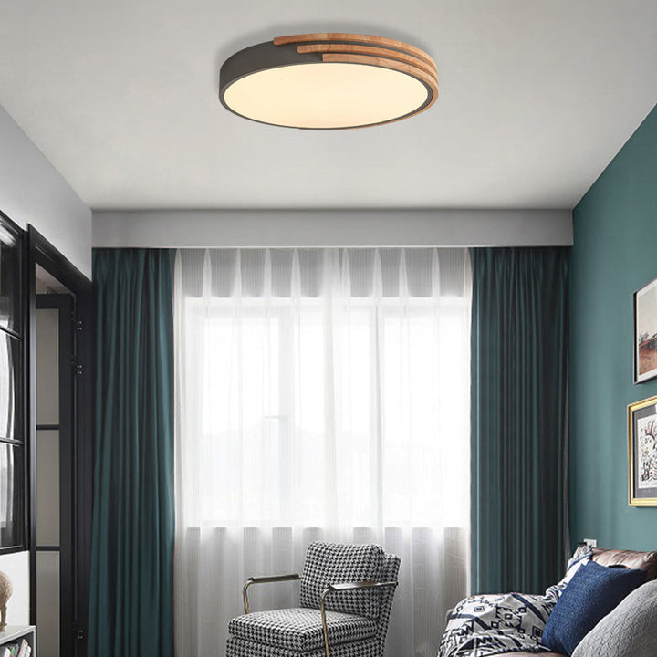 Grey and wood round flush mount ceiling lamp in contemporary living space with curtains