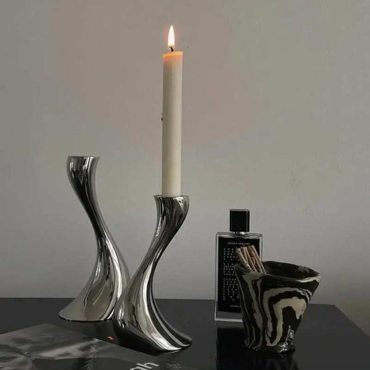 Two ceramic candle holders in different heights with curved sculptural design
