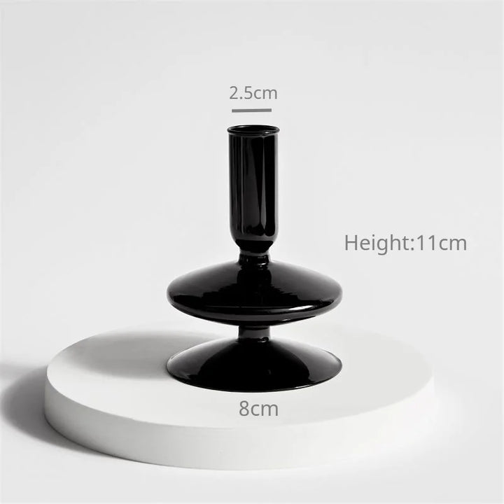 Black glass taper candle holder measuring 4.3 in (11 cm) tall and 3.1 in (8 cm) wide with 1 in (2.5 cm) opening