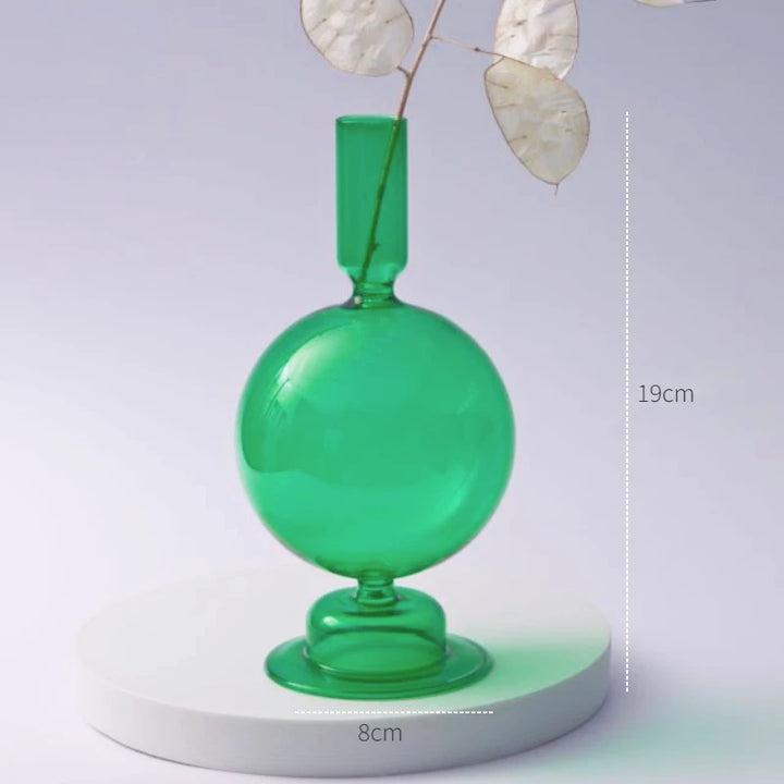 Green glass sphere candle holder measuring 7.5 in (19 cm) tall and 3.1 in (8 cm) wide displayed with dried branch