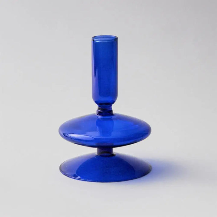 Dark blue glass candle holder with single rounded base and cylindrical stem in Nordic-inspired design