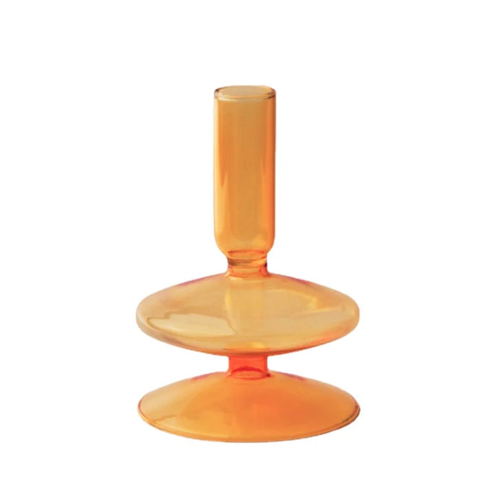 Orange glass candle holder with sleek tapered neck and rounded base in modern Nordic style