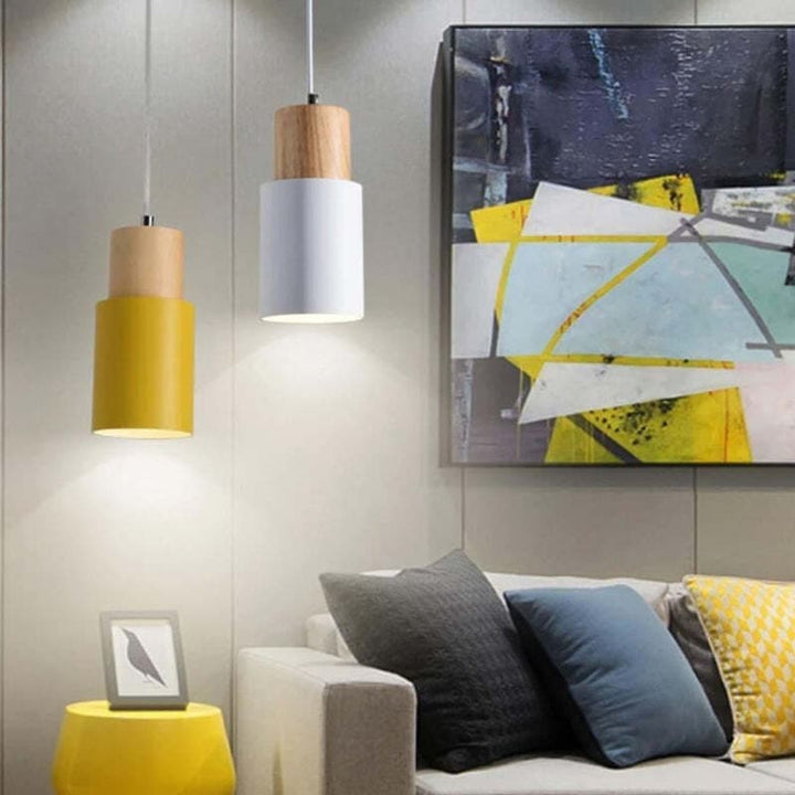 Yellow and white Nordic pendant lights illuminating a modern living room with abstract wall art.