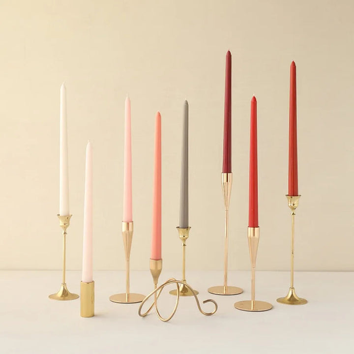Gradient wax taper candles in gold holders, red/grey/pink, minimalist table décor