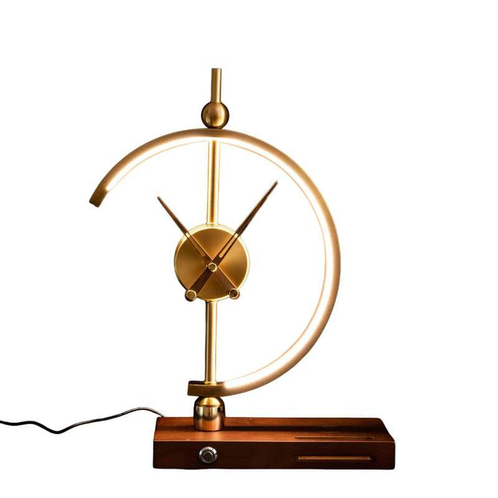 Gold LED lamp clock with wooden base and visible power cord on a white background.